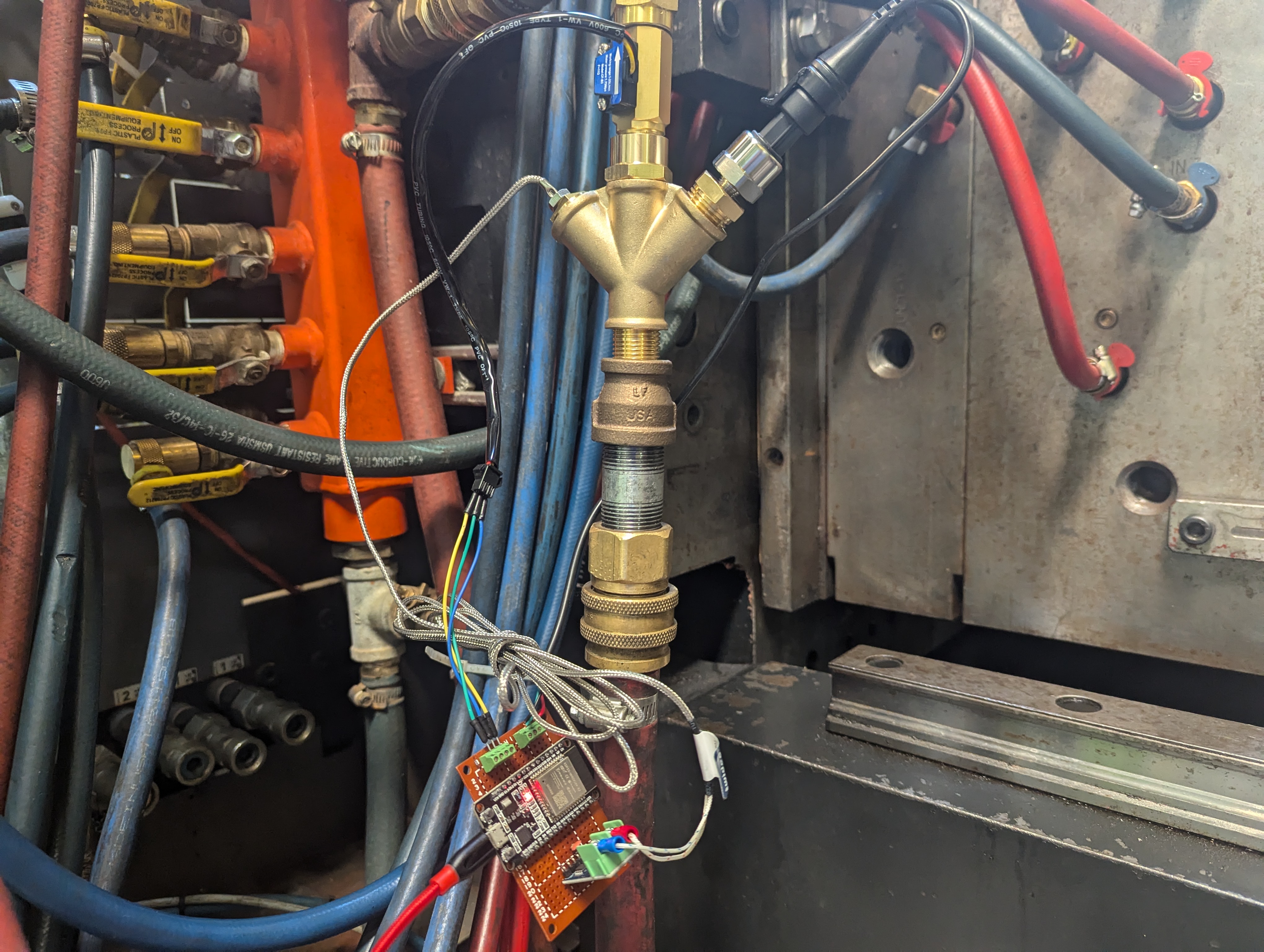 An image of an injection molding machine with a device on it